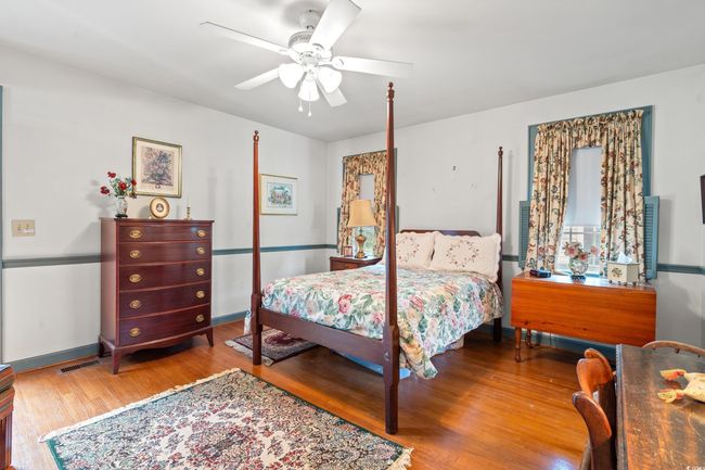Bedroom featuring wood finished floors and a ceiling fan | Image 12