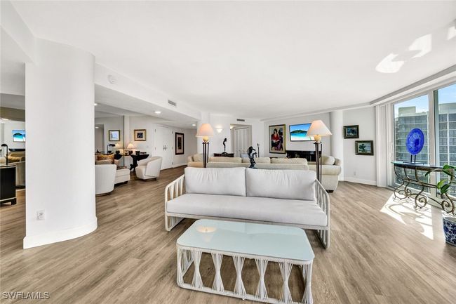 Living area with visible vents, light wood-style flooring, and baseboards | Image 7