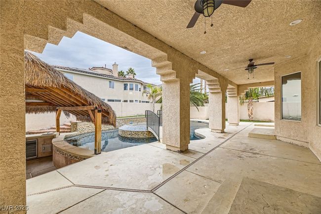 Fenced backyard featuring a ceiling fan and a patio | Image 39