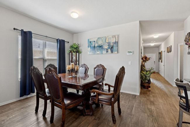 Dining space with wood-vinyl finished floors and baseboards | Image 20