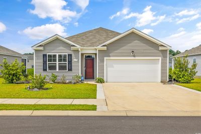 Ranch-style home with a front lawn and a garage | Image 1