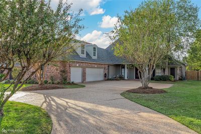 View of front facade with a garage and a front lawn | Image 2