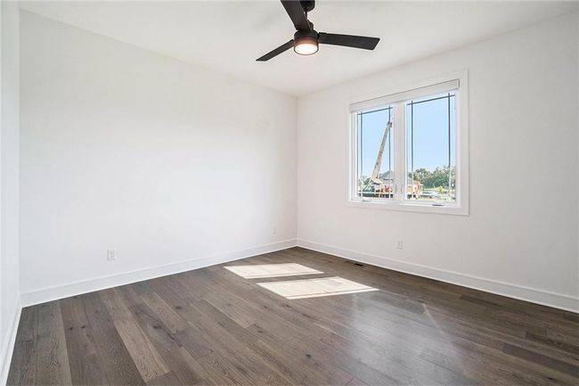 Unfurnished room featuring baseboards, dark wood finished floors, and a ceiling fan | Image 36