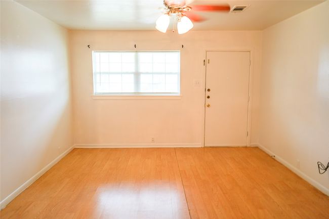 Spare room featuring visible vents, wood finished floors, baseboards, and ceiling fan | Image 5