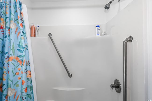 Bathroom featuring a shower with shower curtain | Image 22