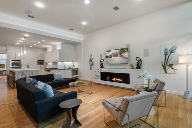Living room with baseboards, a fireplace, light wood-style floors, and recessed lighting | Image 6