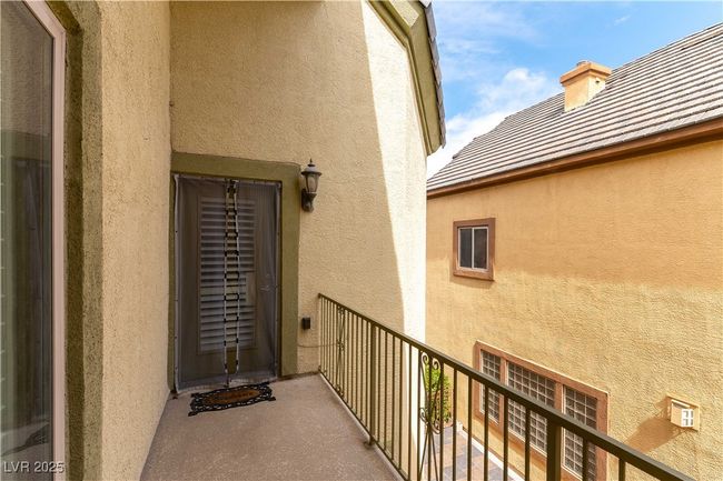 View of exterior entry with a balcony and stucco siding | Image 33
