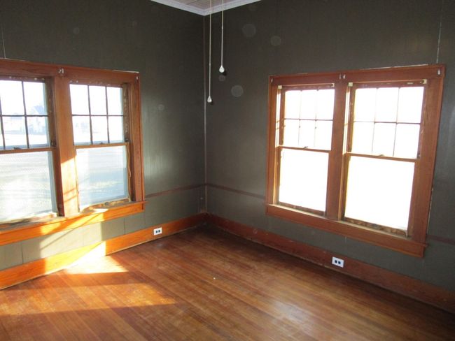 Unfurnished room featuring plenty of natural light, baseboards, and wood finished floors | Image 12
