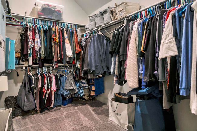 Walk in closet featuring lofted ceiling and carpet | Image 19