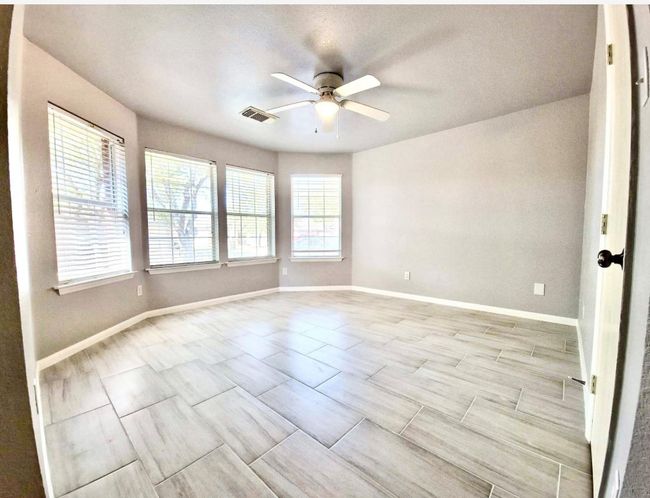 Empty room featuring a ceiling fan and baseboards | Image 12