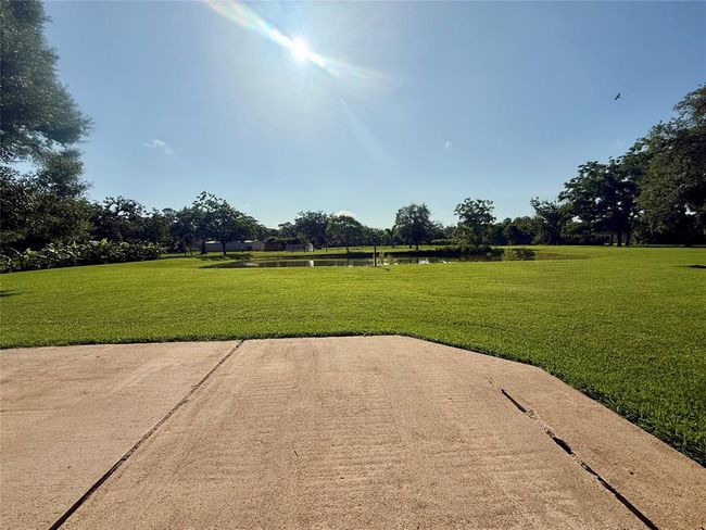 Additional concrete patio off the breezeway between house and garage | Image 44