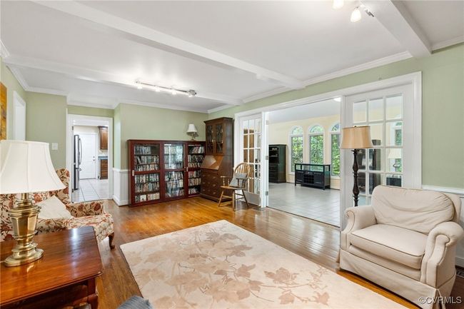 Living area with rail lighting, wood finished floors, crown molding, and beam ceiling | Image 25