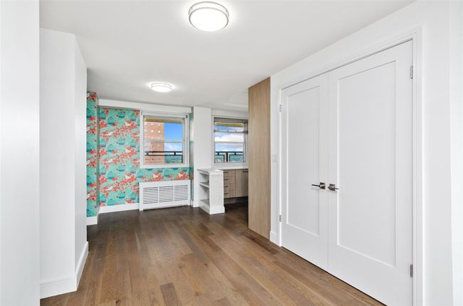 Corridor featuring baseboards and wood finished floors | Image 11