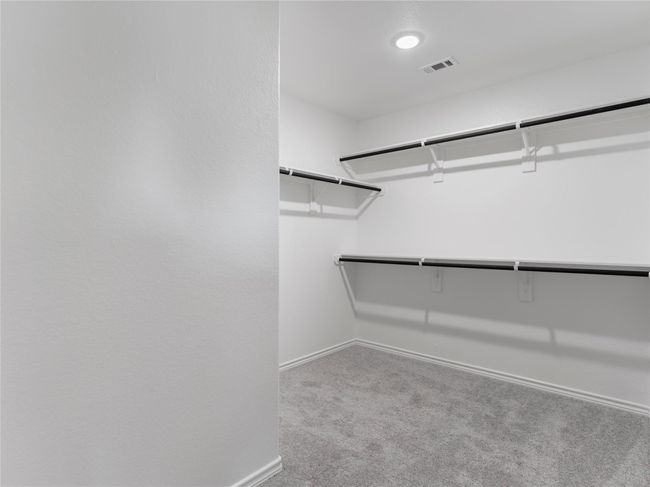 Spacious master closet with convenient built-in shelving. | Image 21