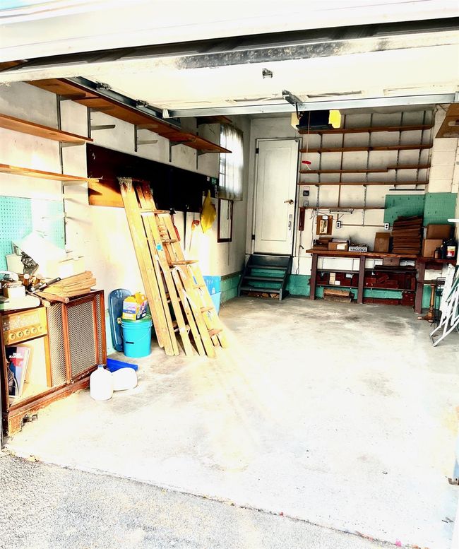 Garage with a workshop area | Image 45
