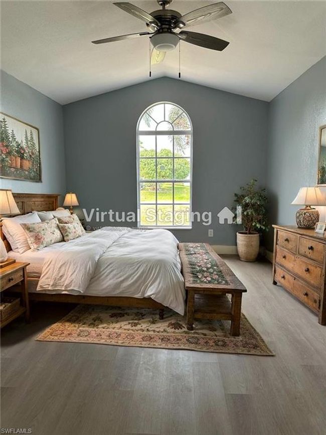 Bedroom featuring lofted ceiling, wood finished floors, and a ceiling fan | Image 14