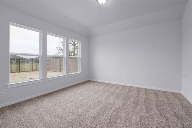 Primary bedroom with lots of windows and view of your beautiful backyard | Image 11