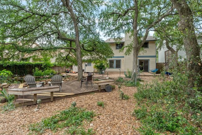 Towering trees and layered landscaping create a natural canopy, offering dappled shade and a sense of privacy that makes the yard feel worlds away from the city | Image 29