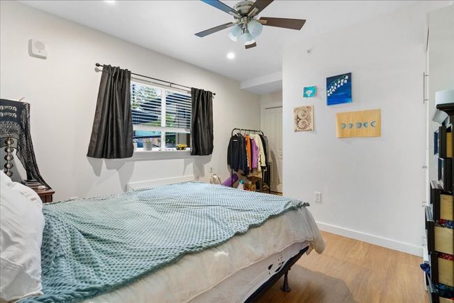High ceilings, a ceiling fan, and a walk-in closet in the bedroom. | Image 8