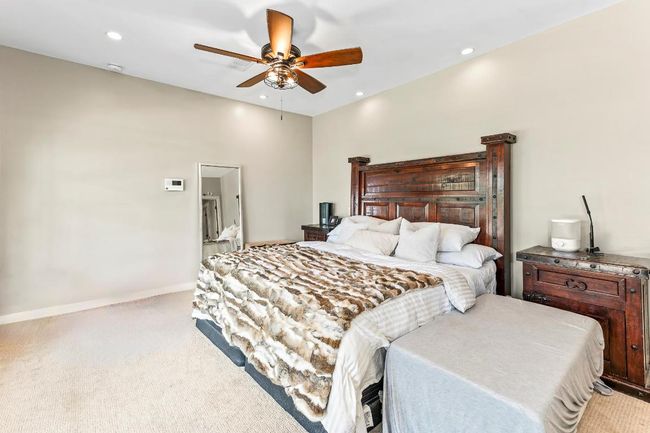 Bedroom featuring light colored carpet, recessed lighting, a ceiling fan, and baseboards | Image 16