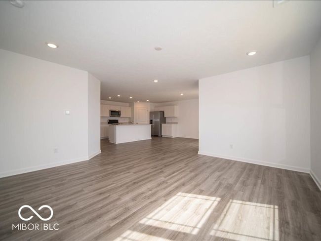 unfurnished living room with recessed lighting, light wood-style floors, and baseboards | Image 17