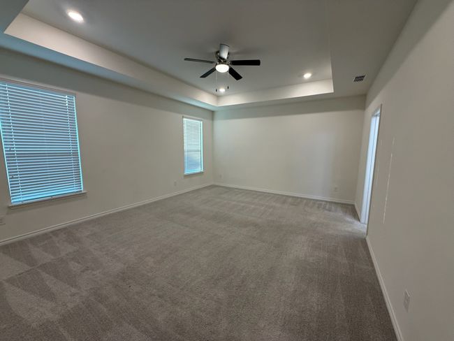 Unfurnished room with a tray ceiling, carpet, a ceiling fan, baseboards, and recessed lighting | Image 30