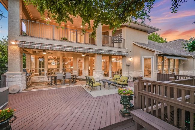 Wooden deck with outdoor dining space and ceiling fans, built-in BBQ. | Image 28
