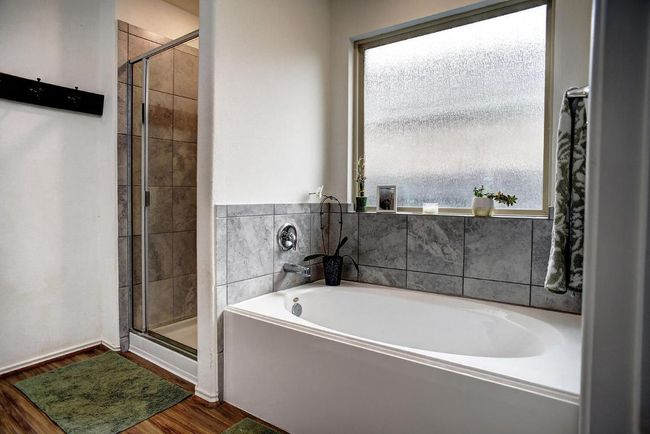 Bathroom featuring a bath, a shower stall, and wood finished floors | Image 21