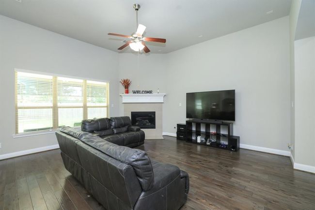 Open concept family room with triple windows to backyard | Image 17