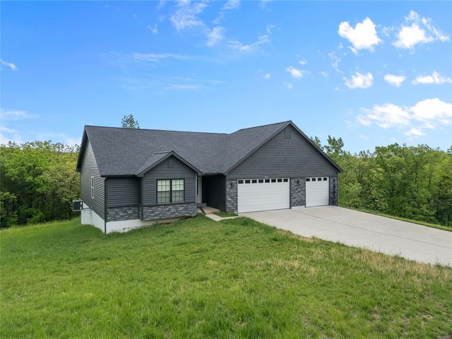 Ranch-style home featuring a shingled roof, an attached garage, a front lawn, stone siding, and driveway | Image 4