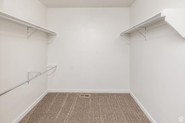 Walk in closet featuring carpet | Image 26