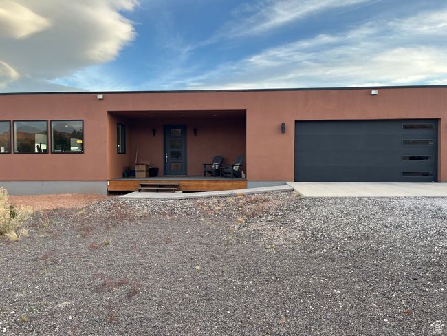 View of front of property with stucco siding and an attached garage | Image 48