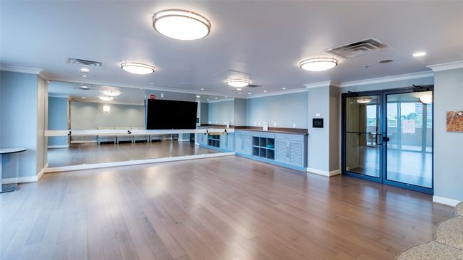 Workout area featuring visible vents, wood finished floors, and crown molding | Image 35