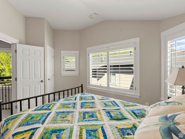 Bedroom with lofted ceiling | Image 22