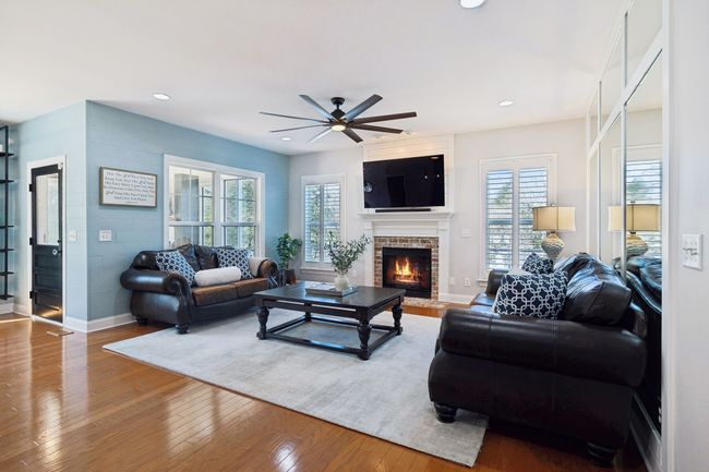 Cozy living space centered around a brick fireplace. | Image 13