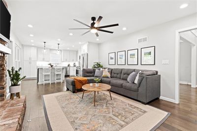 Living room featuring ceiling fan and dark hardwood / wood-style flooring | Image 3