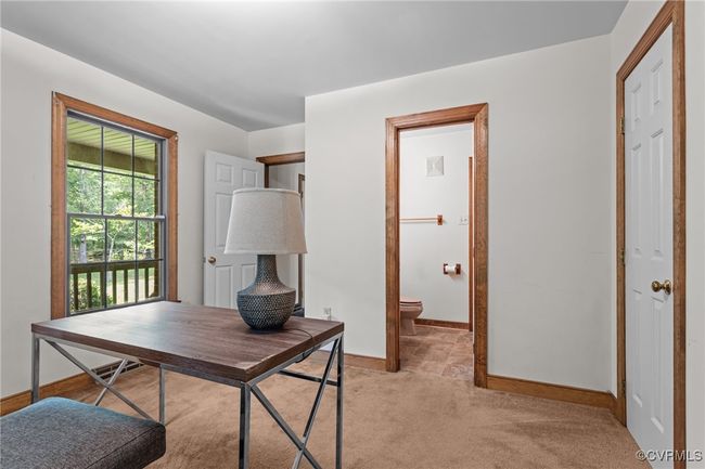 Home office featuring light carpet and baseboards | Image 13