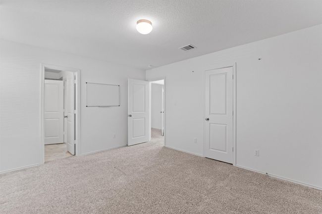Empty room featuring baseboards, light colored carpet, visible vents, and a textured ceiling | Image 25