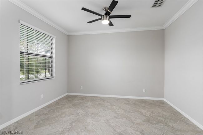 Tiled spare room featuring ornamental molding and ceiling fan | Image 12