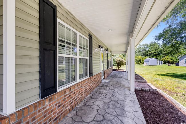Covered porch with a lawn | Image 6