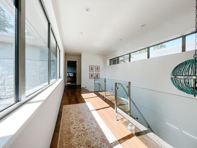 Corridor featuring plenty of natural light and wood finished floors | Image 39