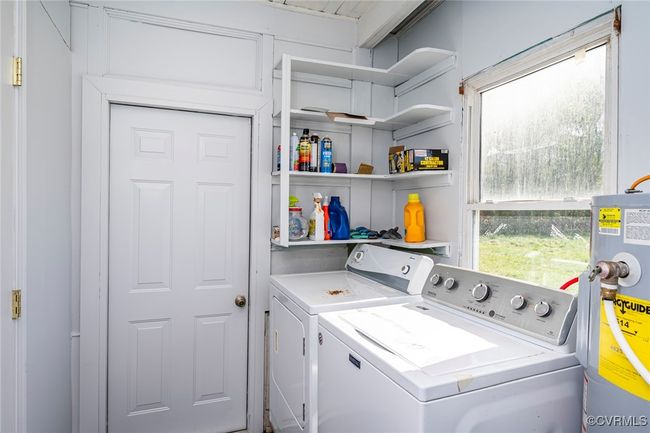 Laundry area with laundry area, separate washer and dryer, and water heater | Image 26