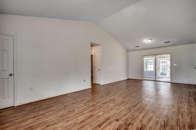 Unfurnished room with lofted ceiling and wood finished floors | Image 19
