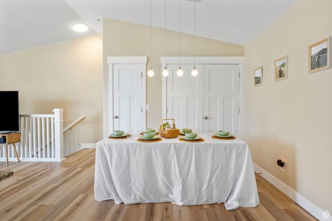 Dining space with baseboards, light wood-style floors, and vaulted ceiling | Image 10