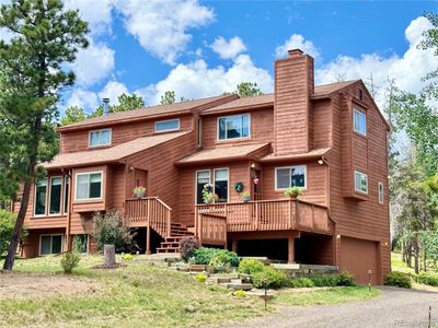 Gorgeous classic mountain retreat with a fresh exterior paint job, a newly renovated front deck, and a stylish circular driveway. This home blends nature, and timeless appeal with modern upgrades, making it a truly desirable property. | Image 2