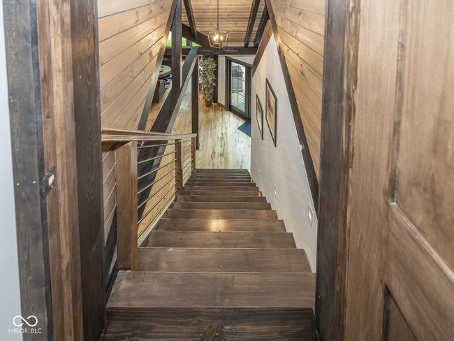 stairs featuring wood walls and wood finished floors | Image 37