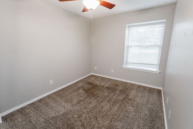 Spare room featuring a ceiling fan and carpet flooring | Image 21