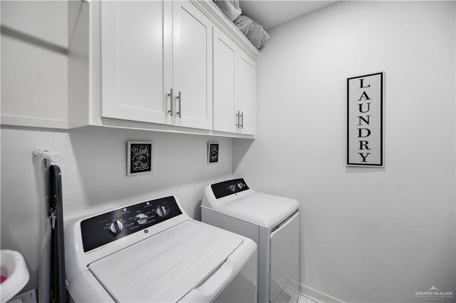 Laundry room with independent washer and dryer, cabinet space, and baseboards | Image 11