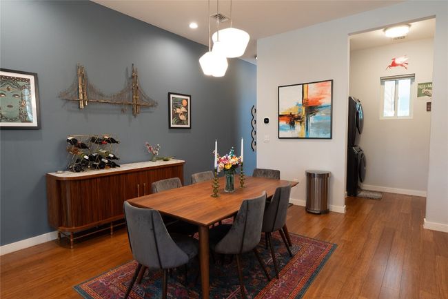 Dining space featuring stacked washer / drying machine, wood finished floors, and recessed lighting | Image 23
