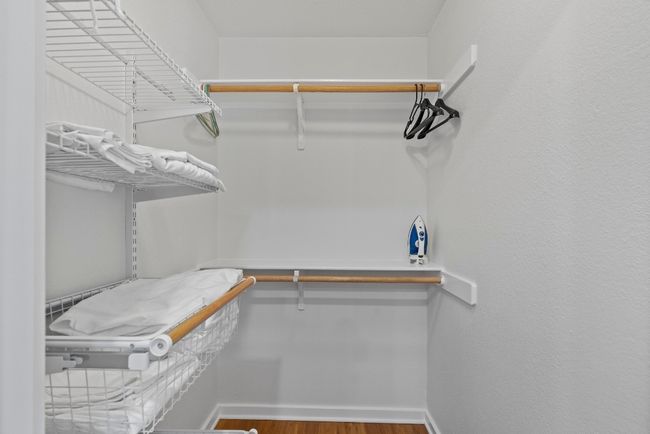 Spacious closet with wood finished floors | Image 20